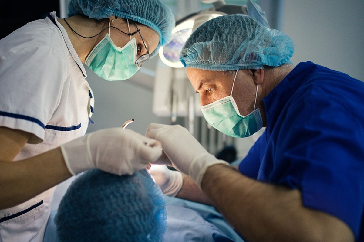 Dentists performing surgery 