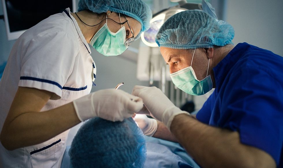 Dentists performing surgery 