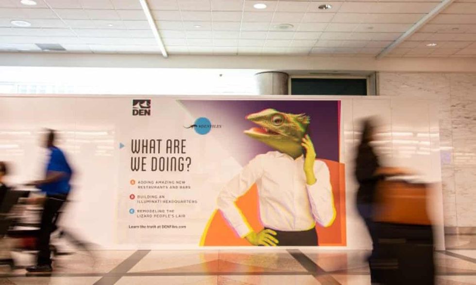 Denver International Airport boardings with a lizard person on it