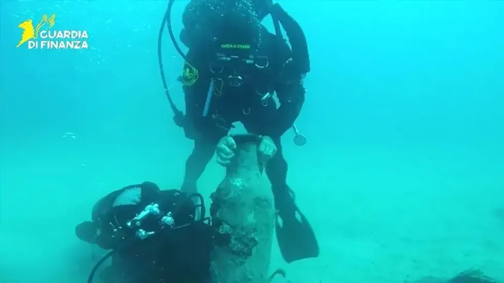Divers carrying the ship's cargo up from the depths