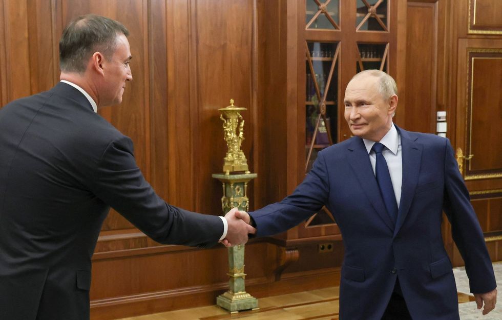 Dmitry Patrushev and Vladimir Putin shaking hands