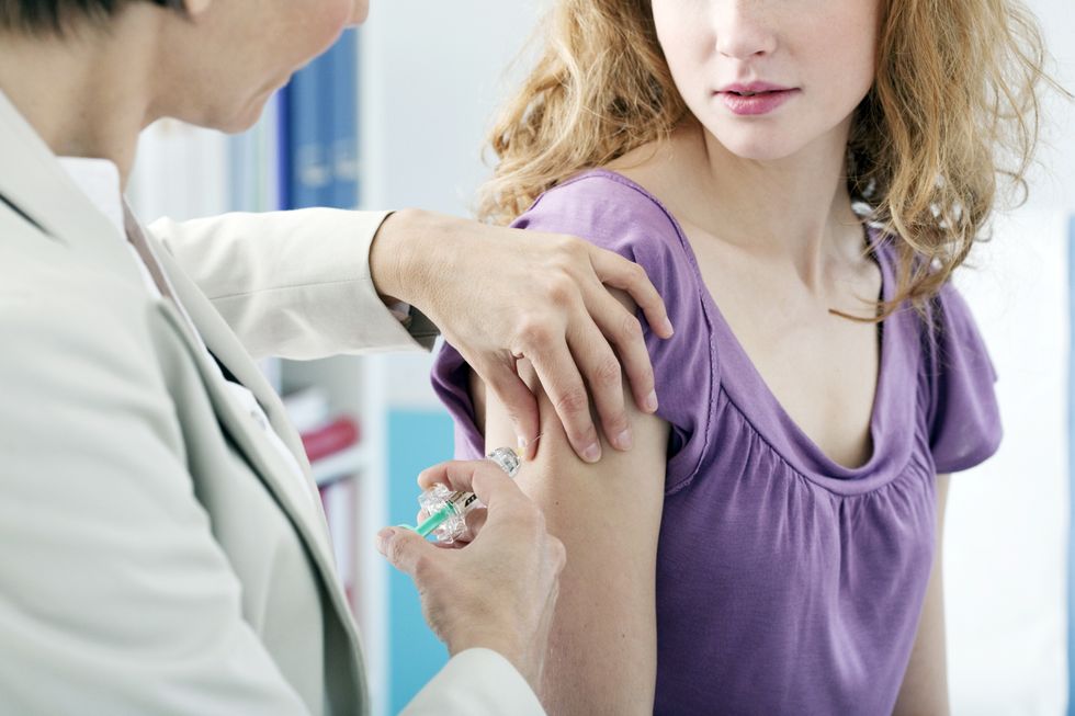 Doctor administering injection