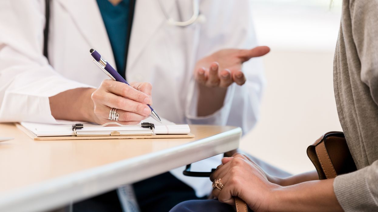 Doctor completing a form