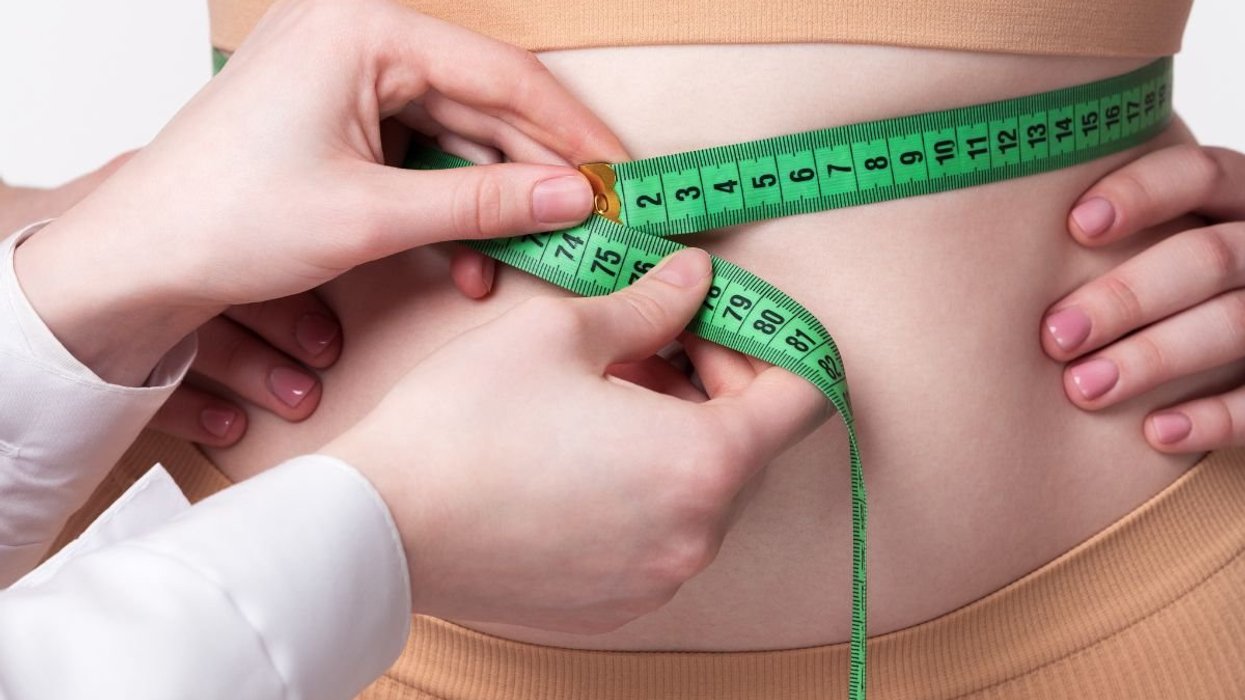 doctor measuring waist