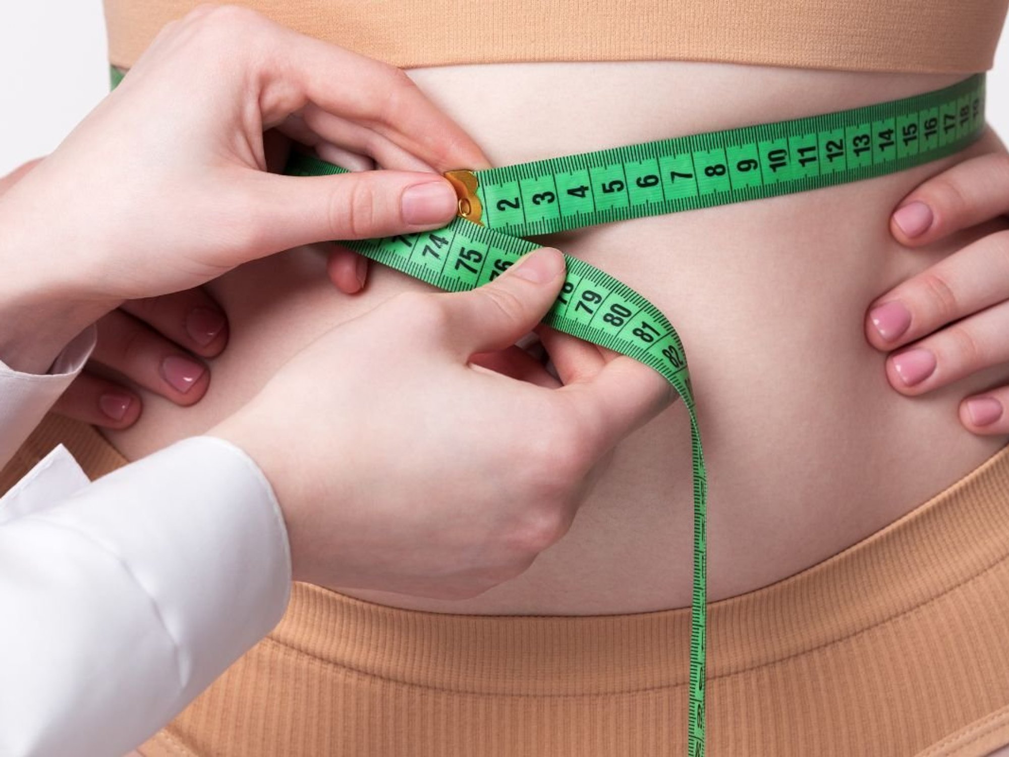 doctor measuring waist
