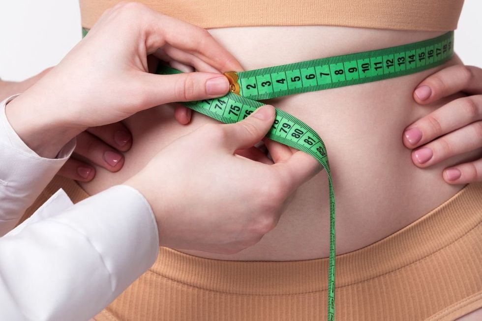 doctor measuring waist