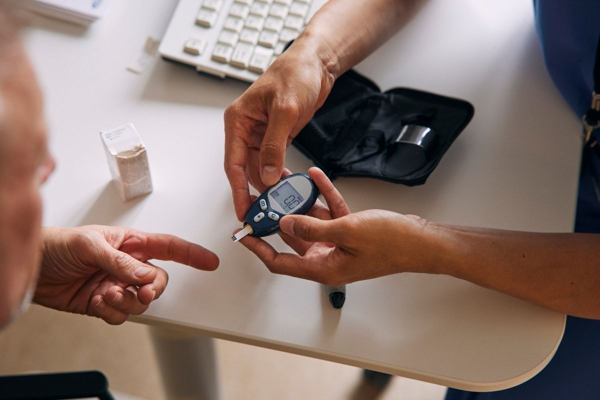 DOCTOR PERFORMING BLOOD SUGAR TEST