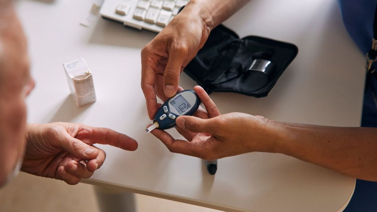 DOCTOR PERFORMING BLOOD SUGAR TEST