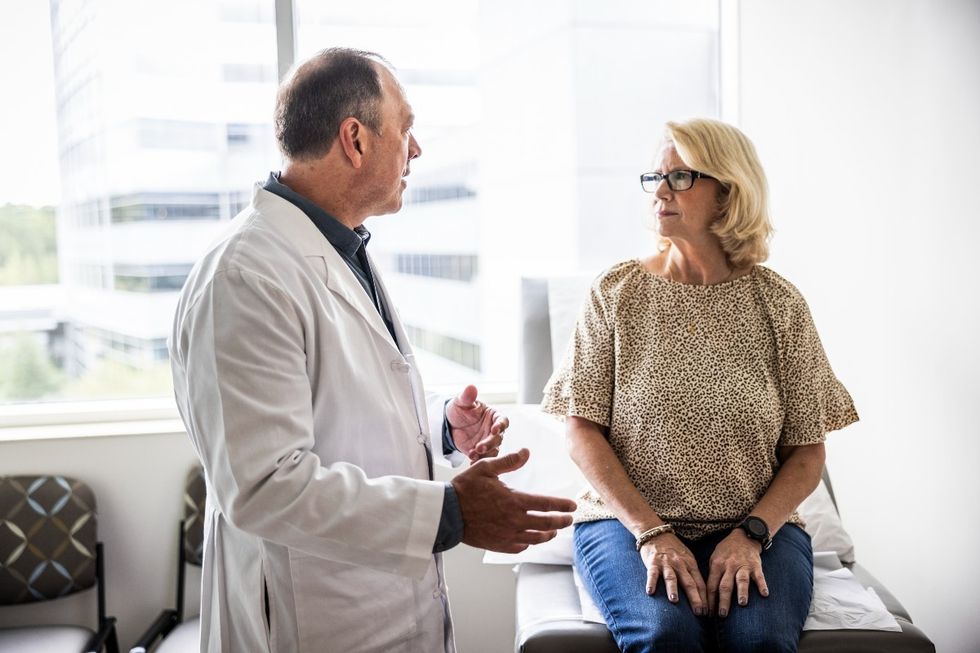 Doctor speaking to older woman in a clinic