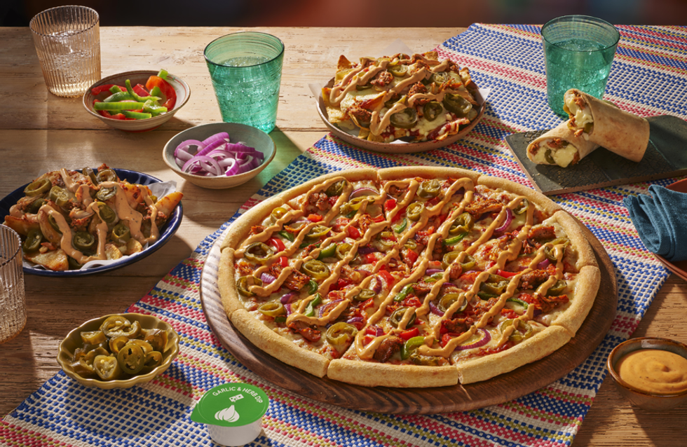 Domino's Mexican menu pizza and nachos on a table