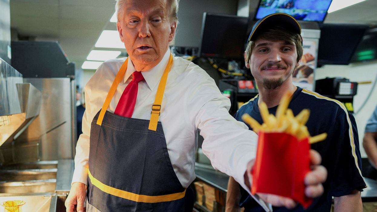 Donald Trump hands french fries to a customer