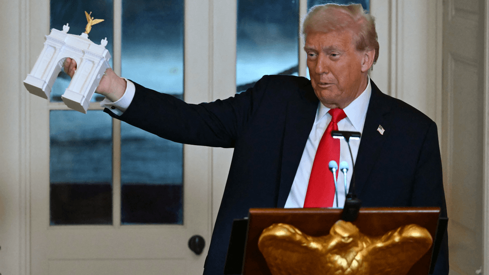 Donald Trump holds up model of arc