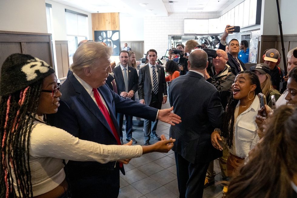 Donald Trump interacting with people at a Chick-fil-A in Atlanta
