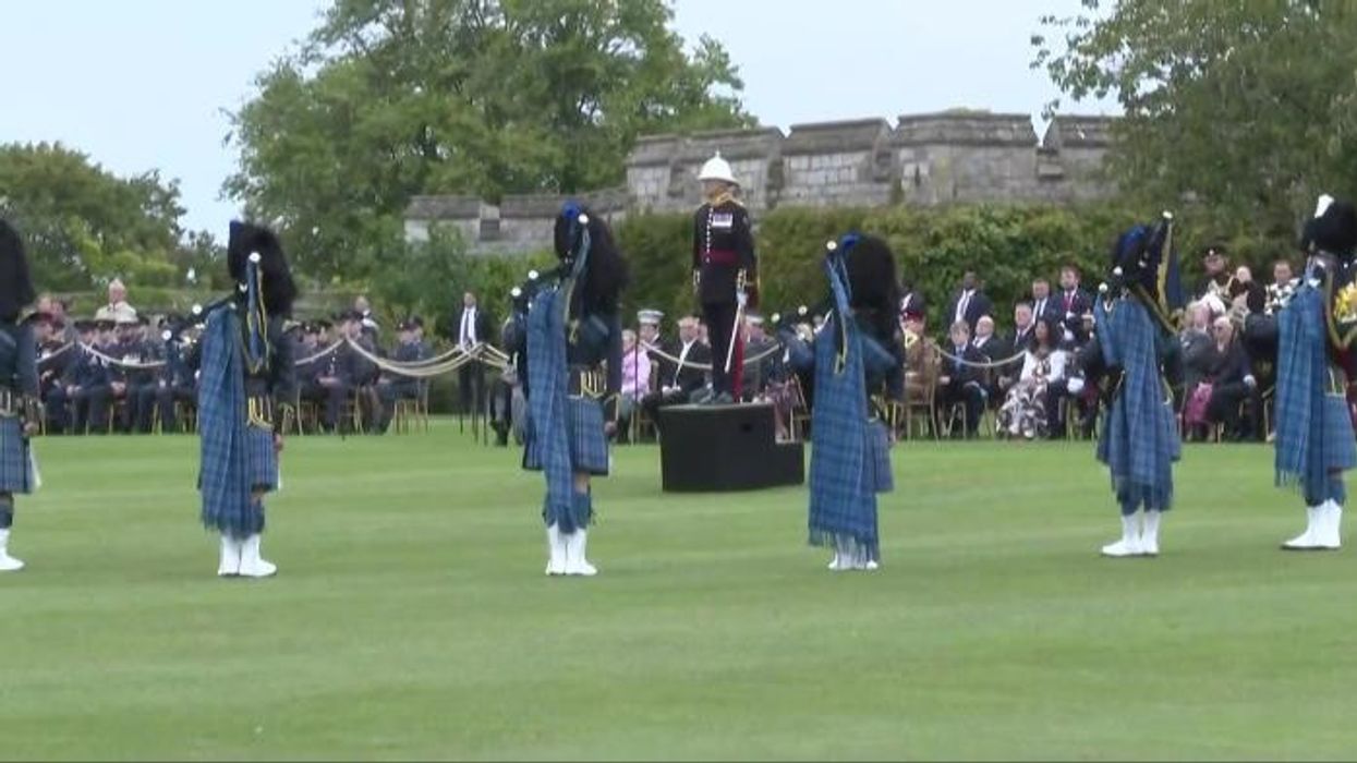 Donald Trump and Melania Trump lay a wreath at Queen Elizabeth II's grave after leaving Windsor Castle