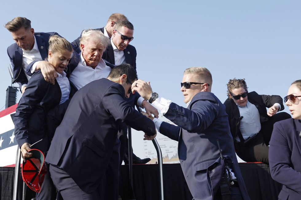 Donald Trump led off the stage by the Secret Service