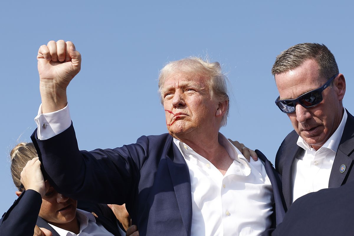 Donald Trump raises fist after being shot