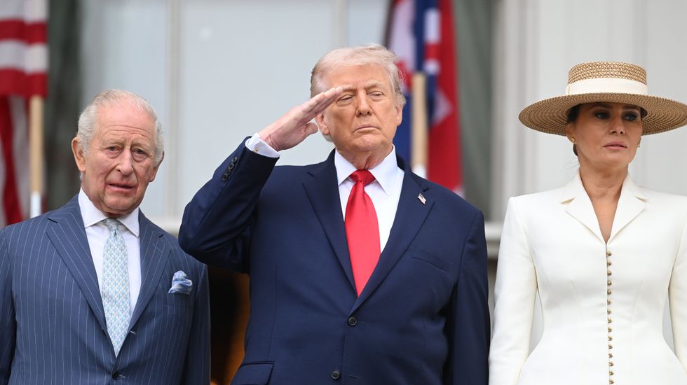 Donald Trump salutes as the national anthem is played for King Charles
