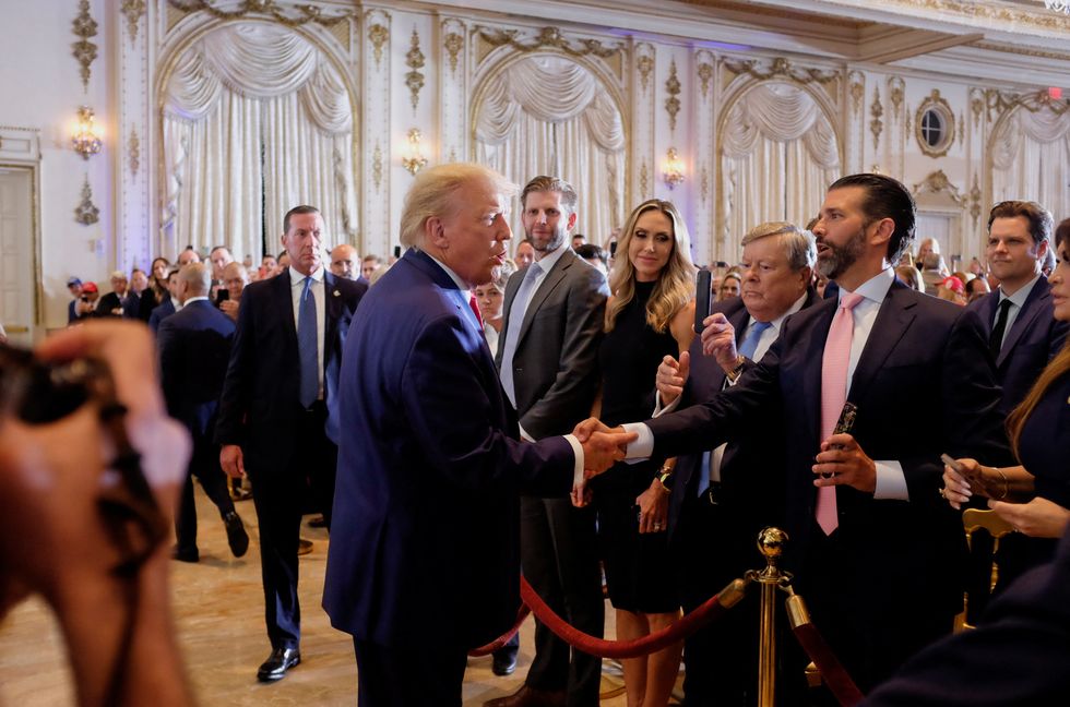 Donald Trump shaking hands with his son