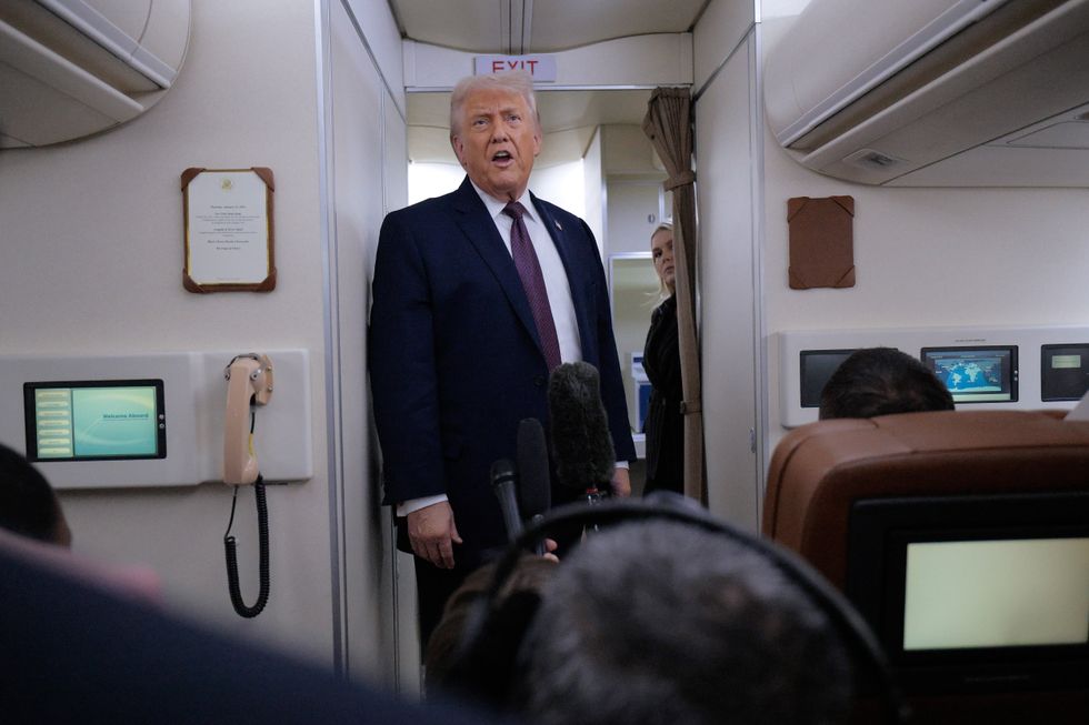 Donald Trump speaks to journalists on Air Force One