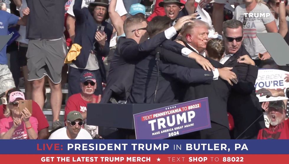 Donald Trump with blood on face after being shot at