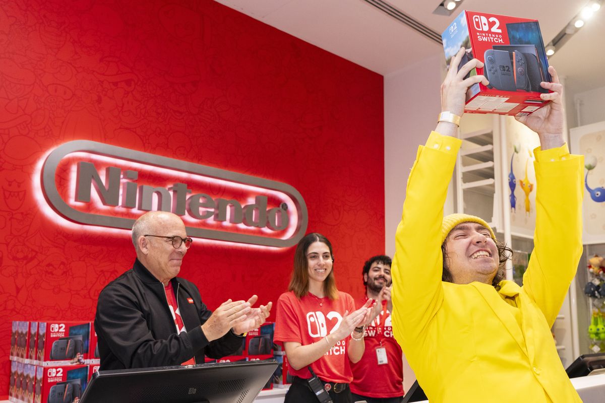 doug bowser pictured clapping as a customer lifts up a nintendo switch 2