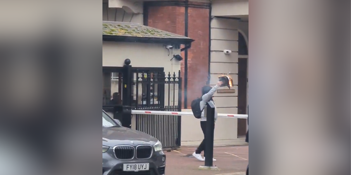 NextImg:Man holding 'burning Koran' attacked 'by man with a knife' outside Turkish embassy