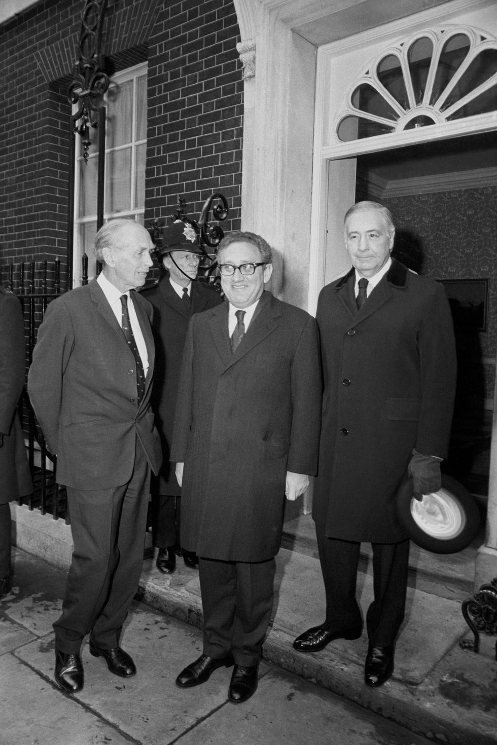 Dr Henry Kissinger, American Secretary of State, centre, arriving at No 10 Downing Street from the Foreign Office with Foreign Secretary Sir Alec Douglas-Home, left, and US Ambassador Walter Annenberg for a working lunch with Edward Heath.