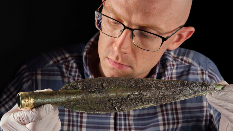 Dr Matthew Knight and the spearhead found within the Carnoustie Hoard