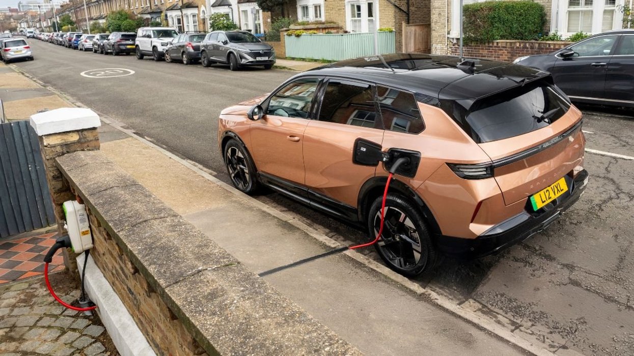 Driver charging Vauxhall electric car with a Kerbo Charge charger
