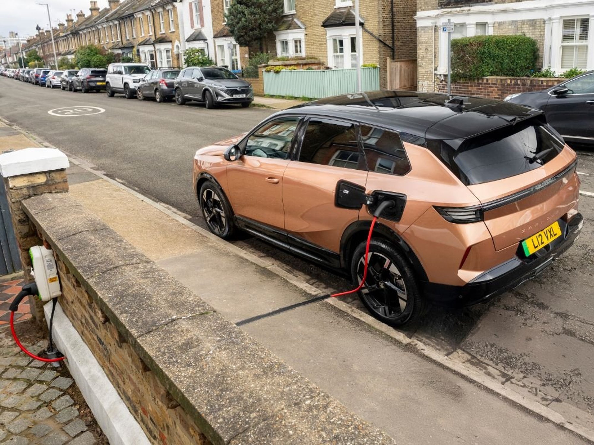 Driver charging Vauxhall electric car with a Kerbo Charge charger