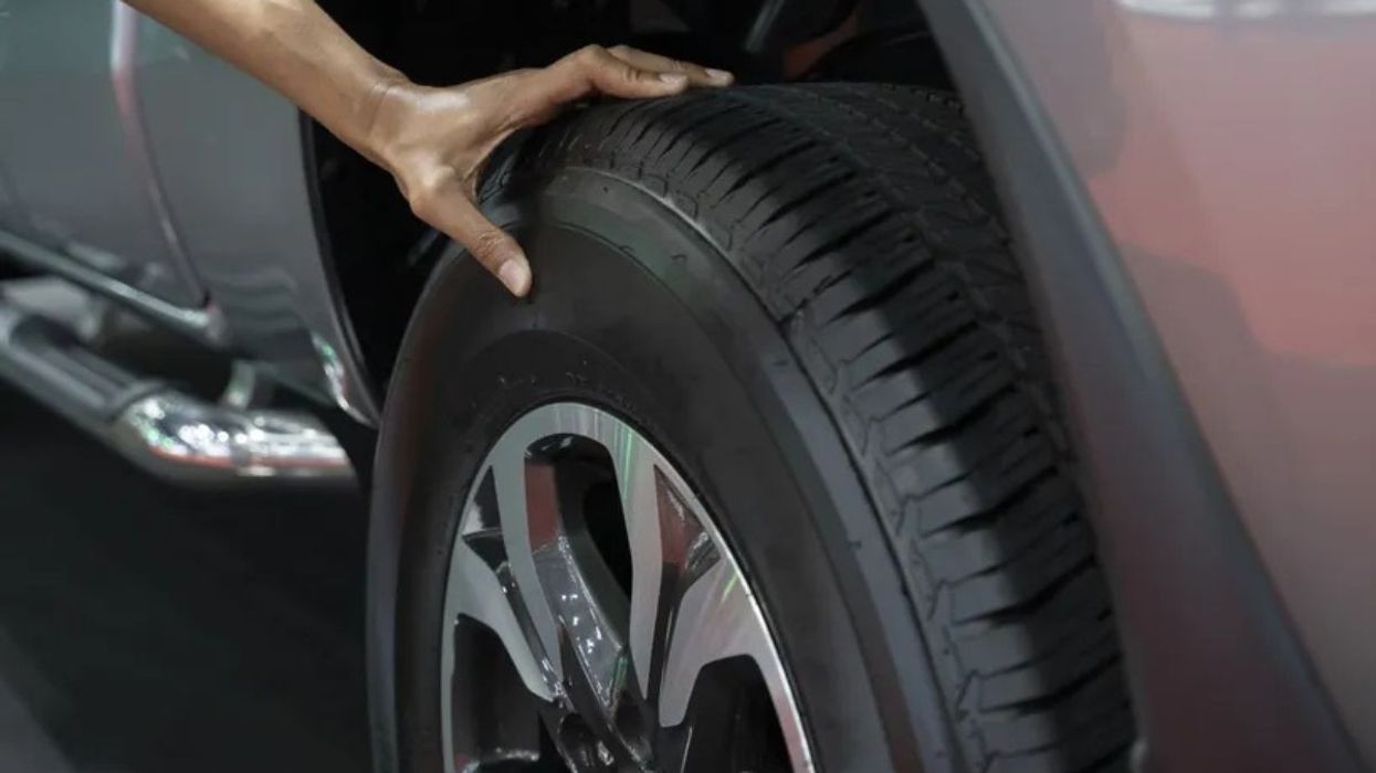 Driver checking tyres