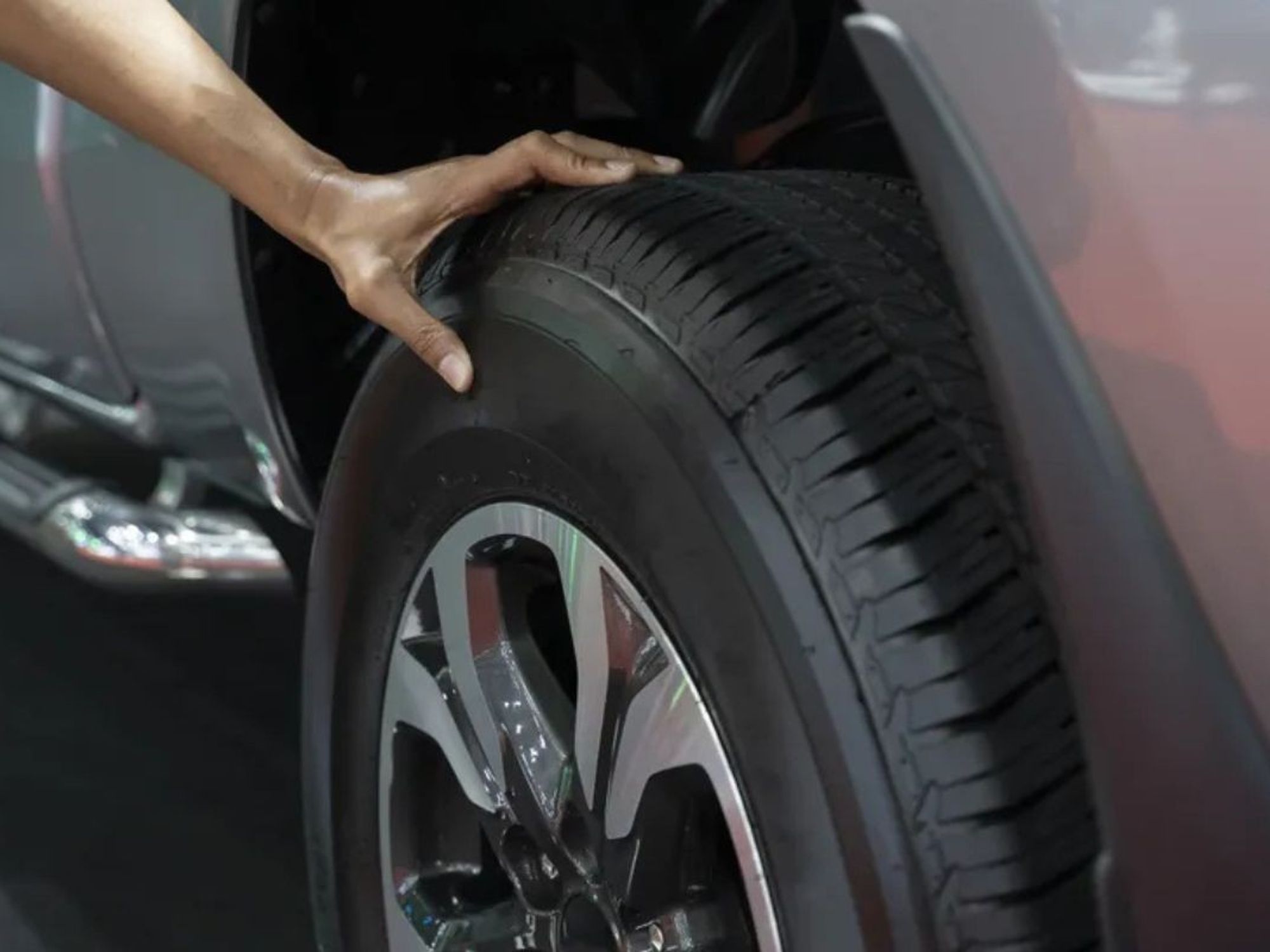 Driver checking tyres