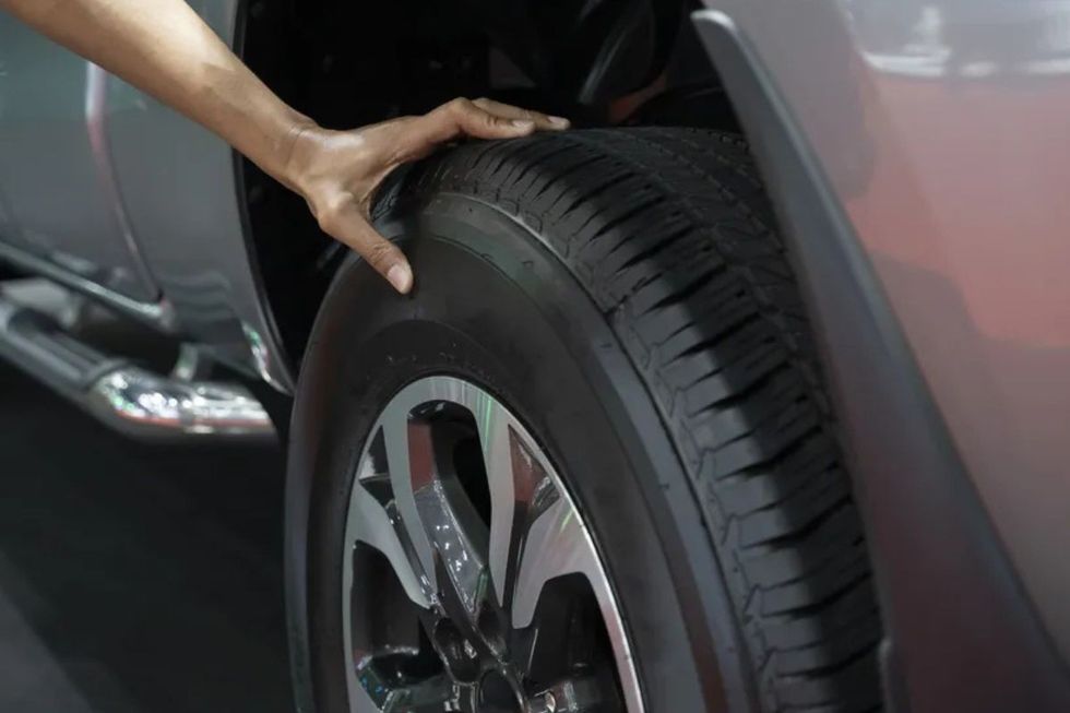 Driver checking tyres