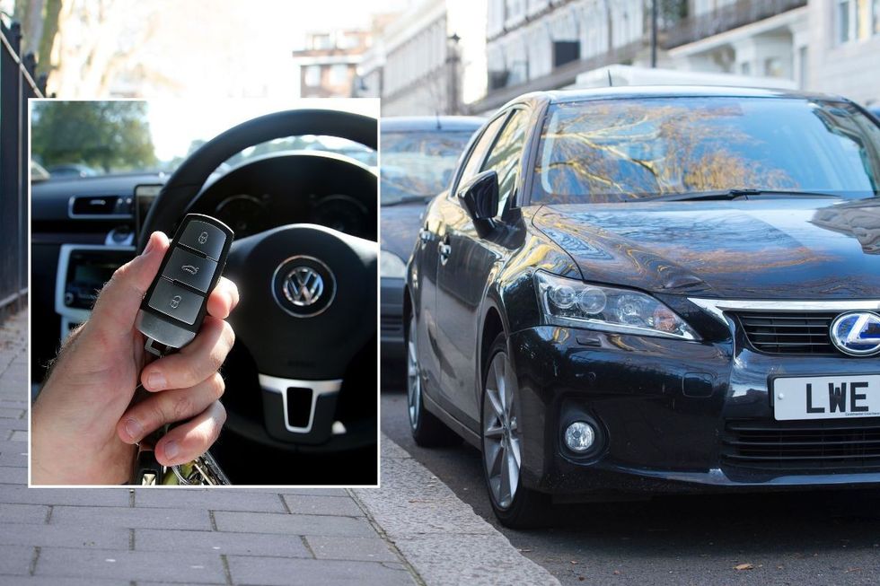 Driver holding a car key and cars parked