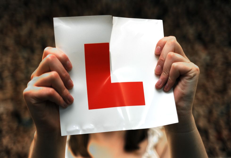 Driver ripping up a learner plate