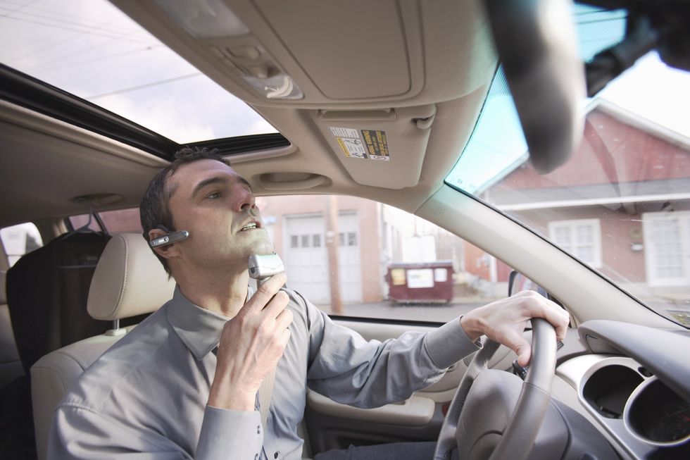 Driver shaving in car