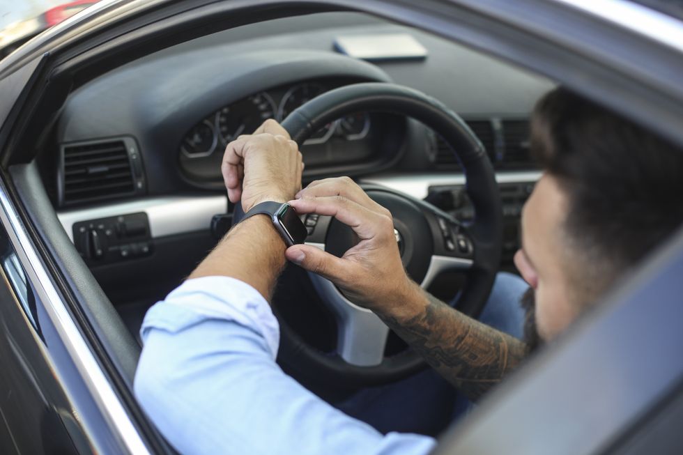 Driver using smartwatch while driving