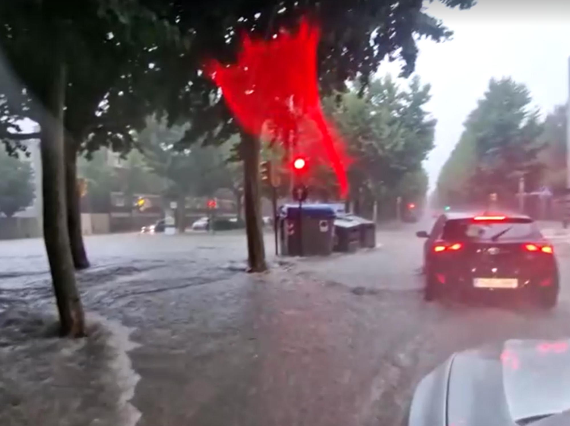 Drivers are seen forcing their cars out of the floodwater
