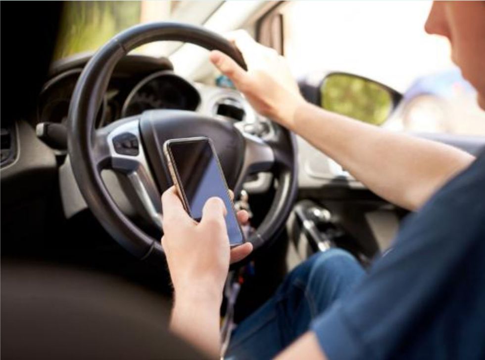 Drivers could face six points on their licence for even touching their mobile phone