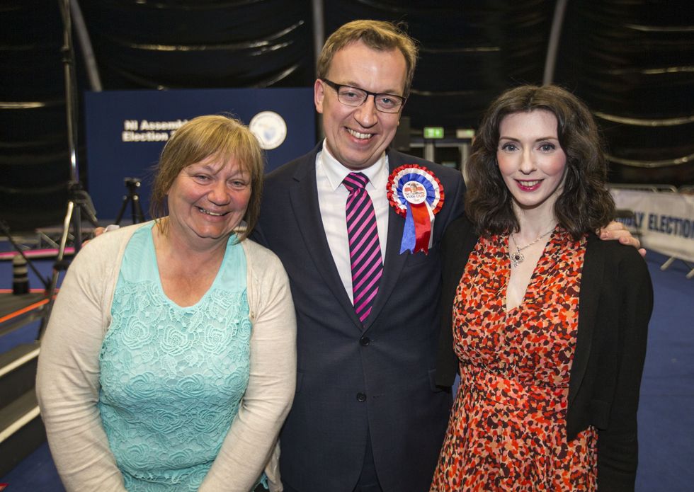 DUP MLA for Belfast South, Christopher Stalford, after his election win in 2016, with his wife Laura and mother Karen Stalford at the Titanic Exhibition Centre in the Northern Ireland Assembly Elections.