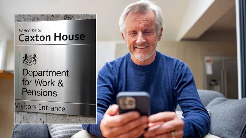 DWP sign and man looking at phone