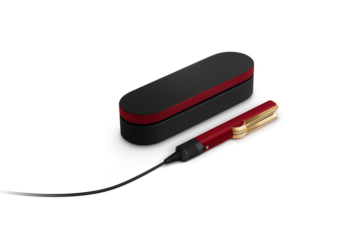 dyson airstraight straighteners lying on their side next to travel case in the new  Red Velvet & Gold colour