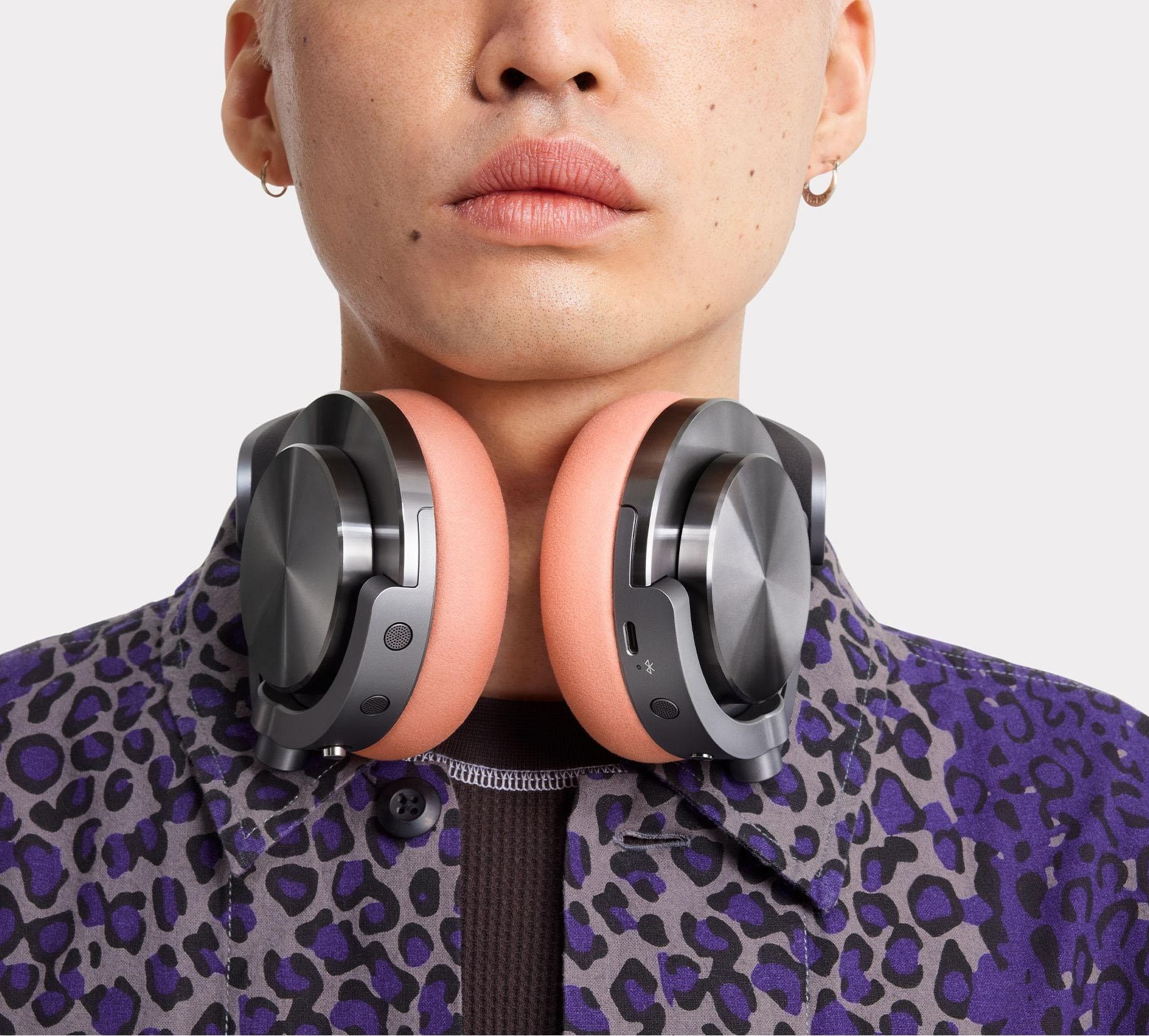 dyson ontrac headphones pictured hanging around an unseen man's neck when not in-use