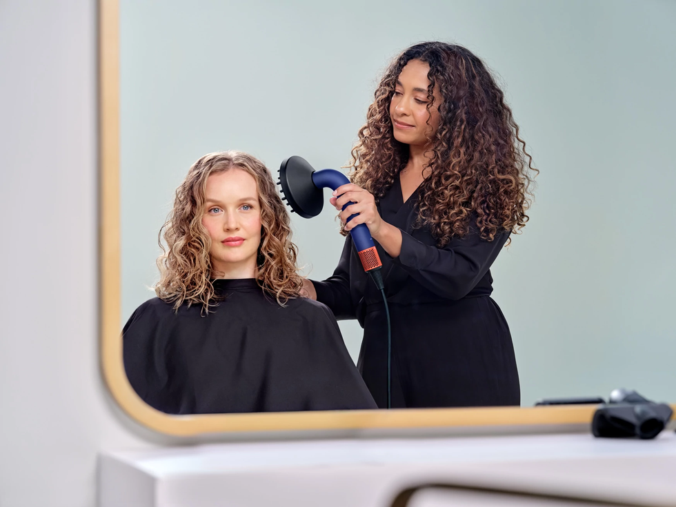 dyson supersonic r hair dryer pictured being used by a professional hair dresser