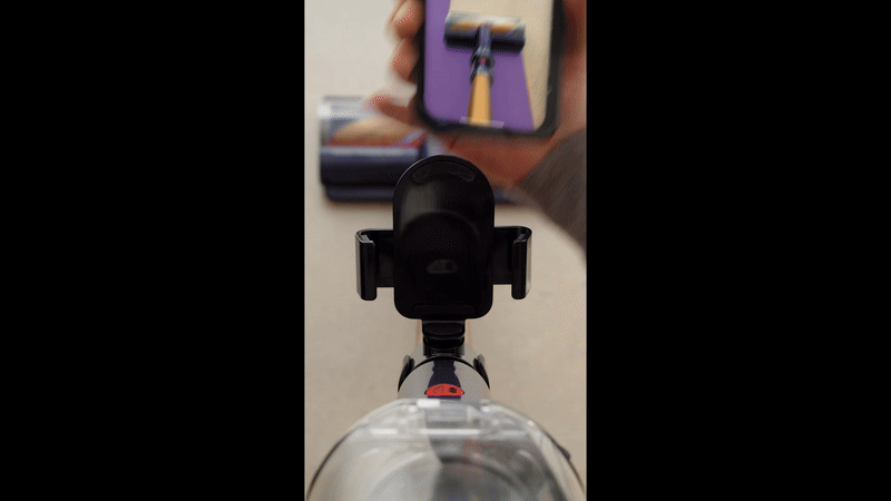 dyson vacuum cleaner with purple lines to show where the head has already travelled, and where is still left to clean