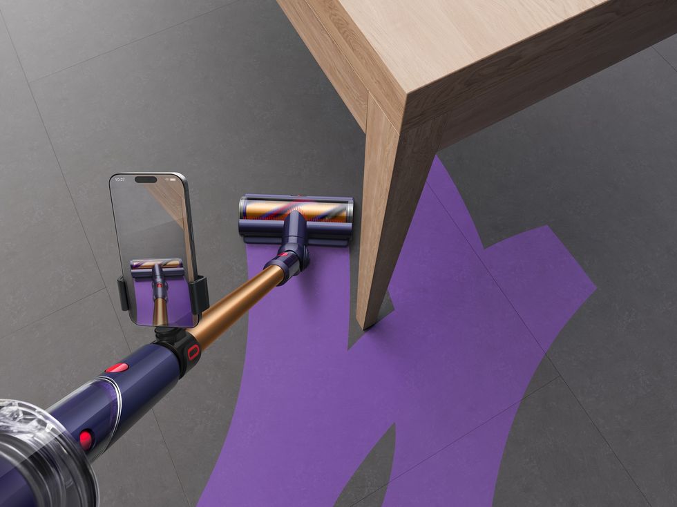 dyson vacuum cleaner with purple lines to show where the head has already travelled, and where is still left to clean