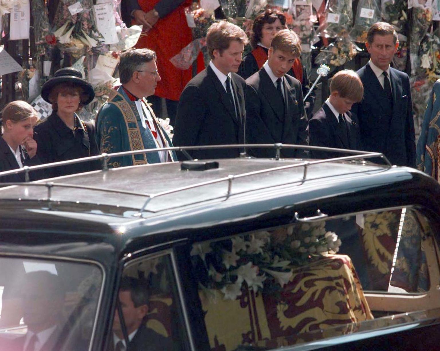 Earl Spencer (4th left) Prince William, Prince Harry and The Prince of Wales (far right) watch the coffin of Diana, Princess of Wales, leave Westminster Abbey following her funeral.