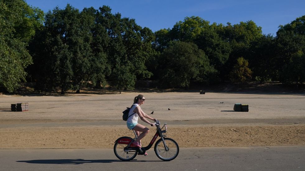 Early morning visitors enjoy the hot weather in Hyde Park, London. The Met Office has issued an amber warning for extreme heat covering four days from Thursday to Sunday for parts of England and Wales as a new heatwave looms. Picture date: Wednesday August 10, 2022.
