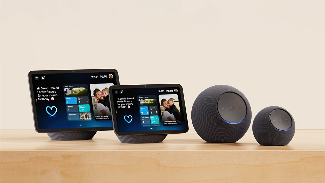 Echo Show 11, Echo Show 8 and Echo Studio and Echo Dot Max pictured side by side on a wooden cabinet