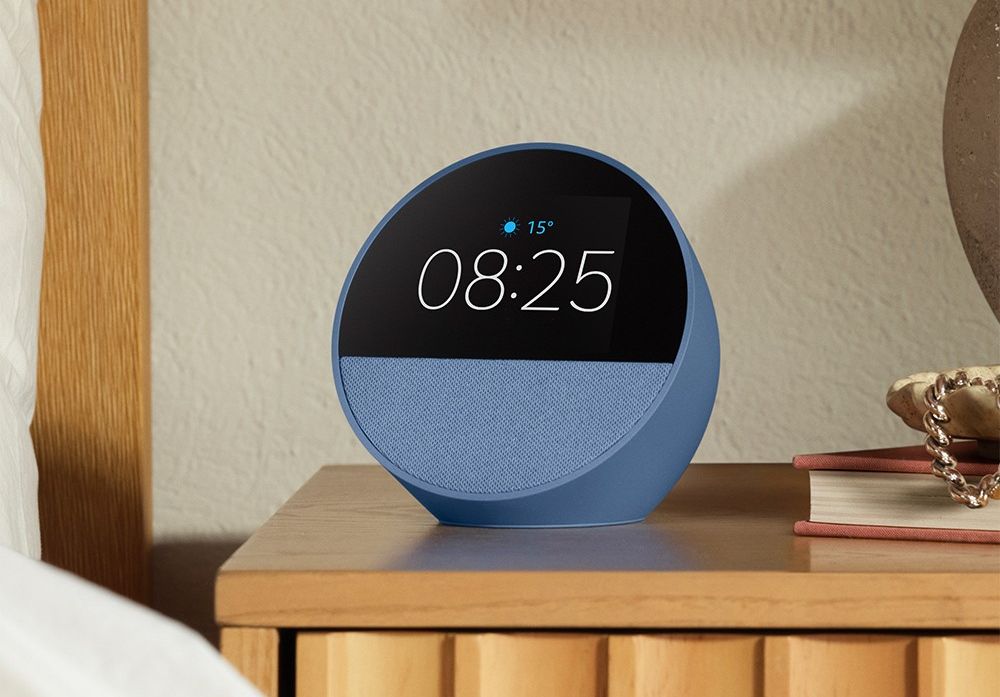 echo spot pictured on a bedside table in ocean blue
